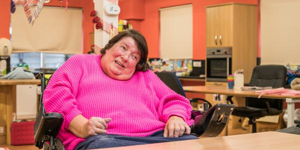 A woman in a wheelchair looking off camera