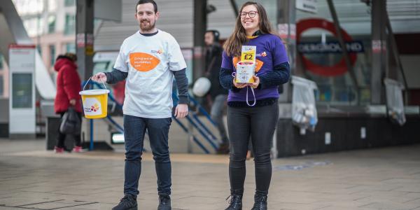 Two people bucket collecting
