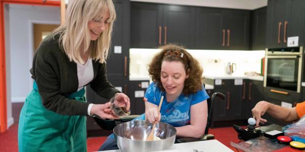 Helen baking with Anna, a member of staff at Gloucestershire House