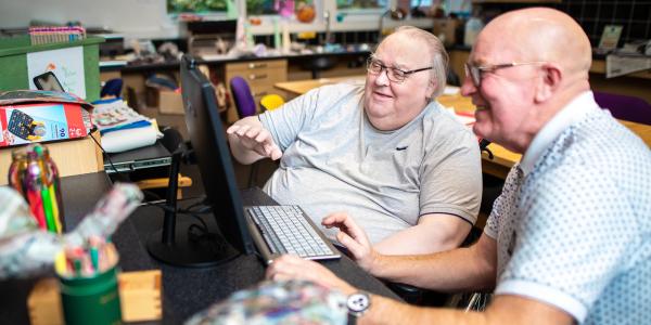 Two men looking at a computer screen
