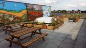 Picnic benches in front of the new mural