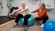 Gloucestershire House resident with occupational therapist using an exercise ball