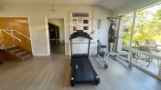 Physio room with laminated floor and rehabilitation equipment 