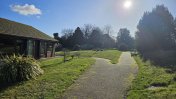 Exterior garden with footpath and hedges with the sun shining on it