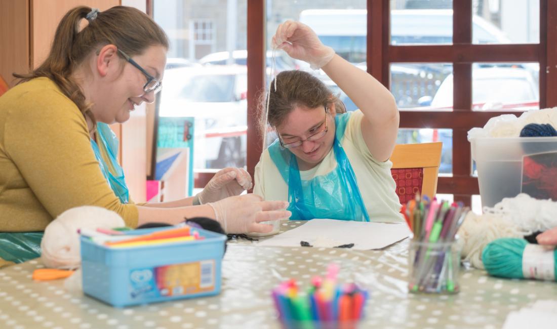 Silvija, a volunteer, with Lynn, a day centre user doing an arts and crafts activity