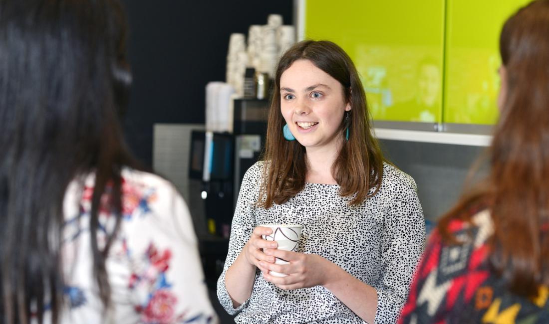 Rebecca chatting with colleagues in the office kitchen during her Overbury placement